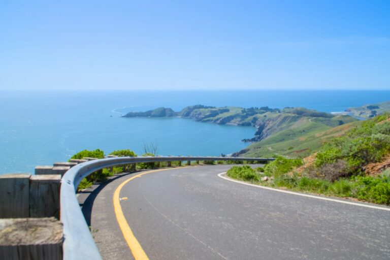 A curving two-lane road with a guardrail above the Pacific coast, the kind of road where motorcycle crashes often happen in Marin County